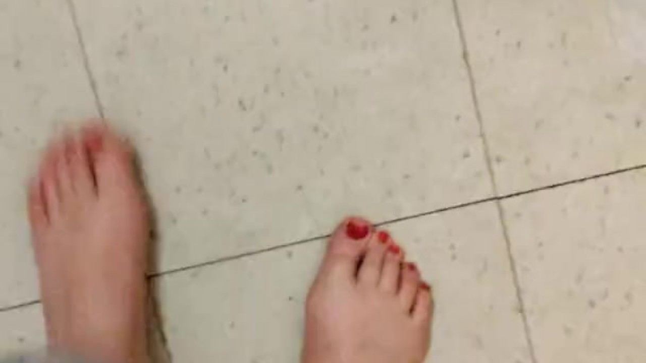 Sensual Mature Woman Shows Off Red Toe Nails