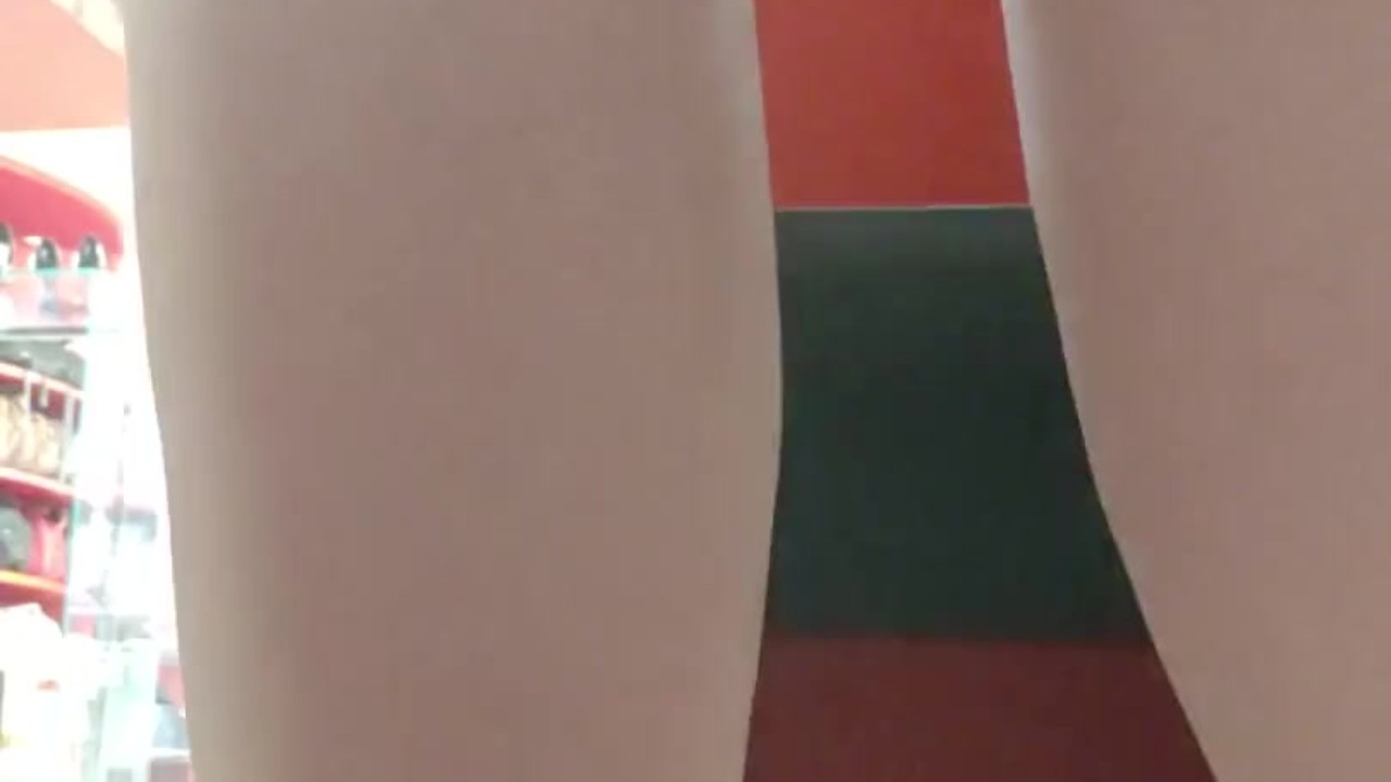 In a public shop Nicoletta tries on sandals with her sweaty feet all dirty
